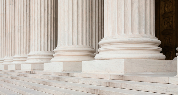 Decorative image for Federal Requirements that shows the bottom of courthouse pillars